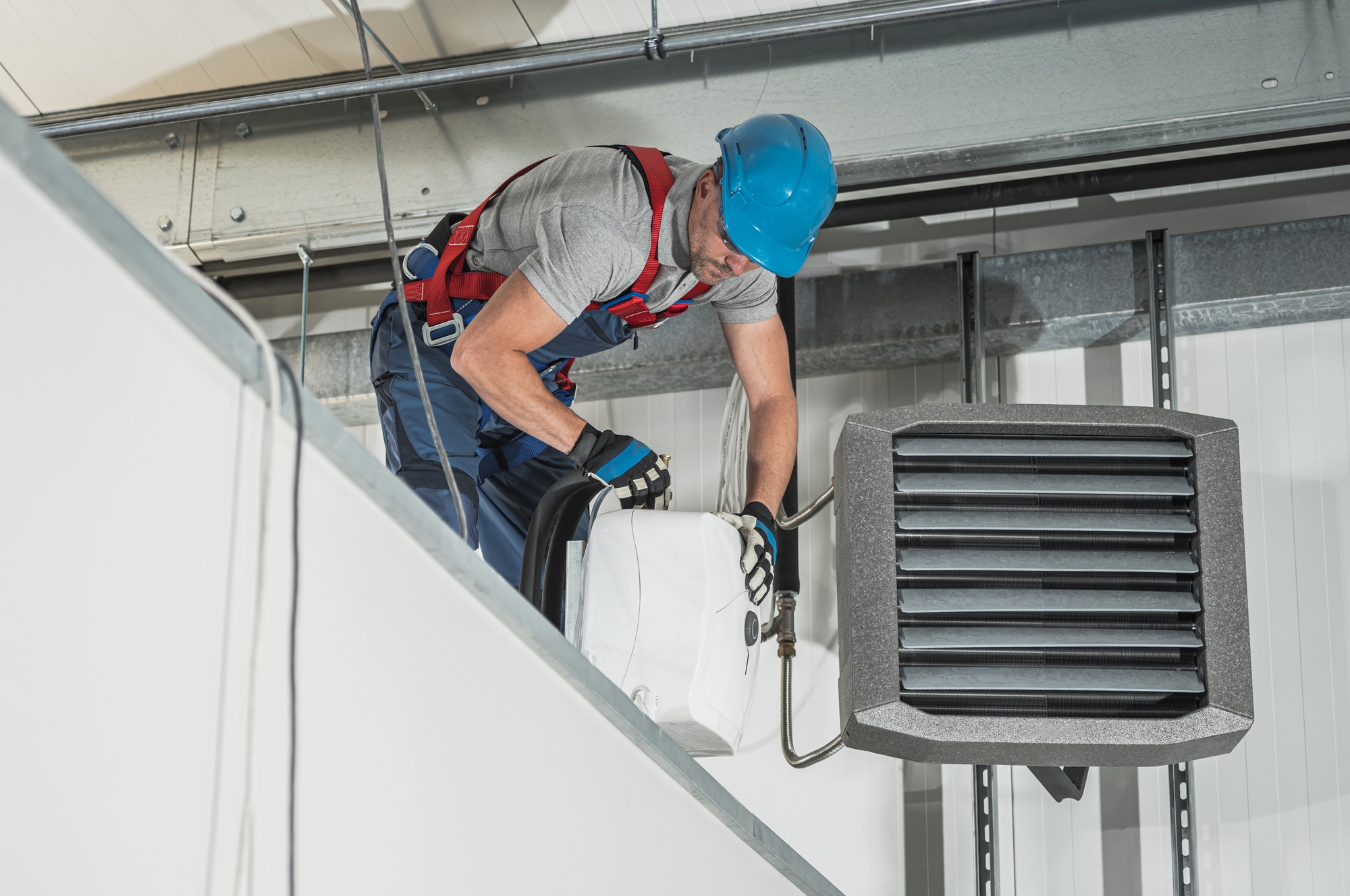 HVAC Technician Installing New Warehouse Air and Water Heaters